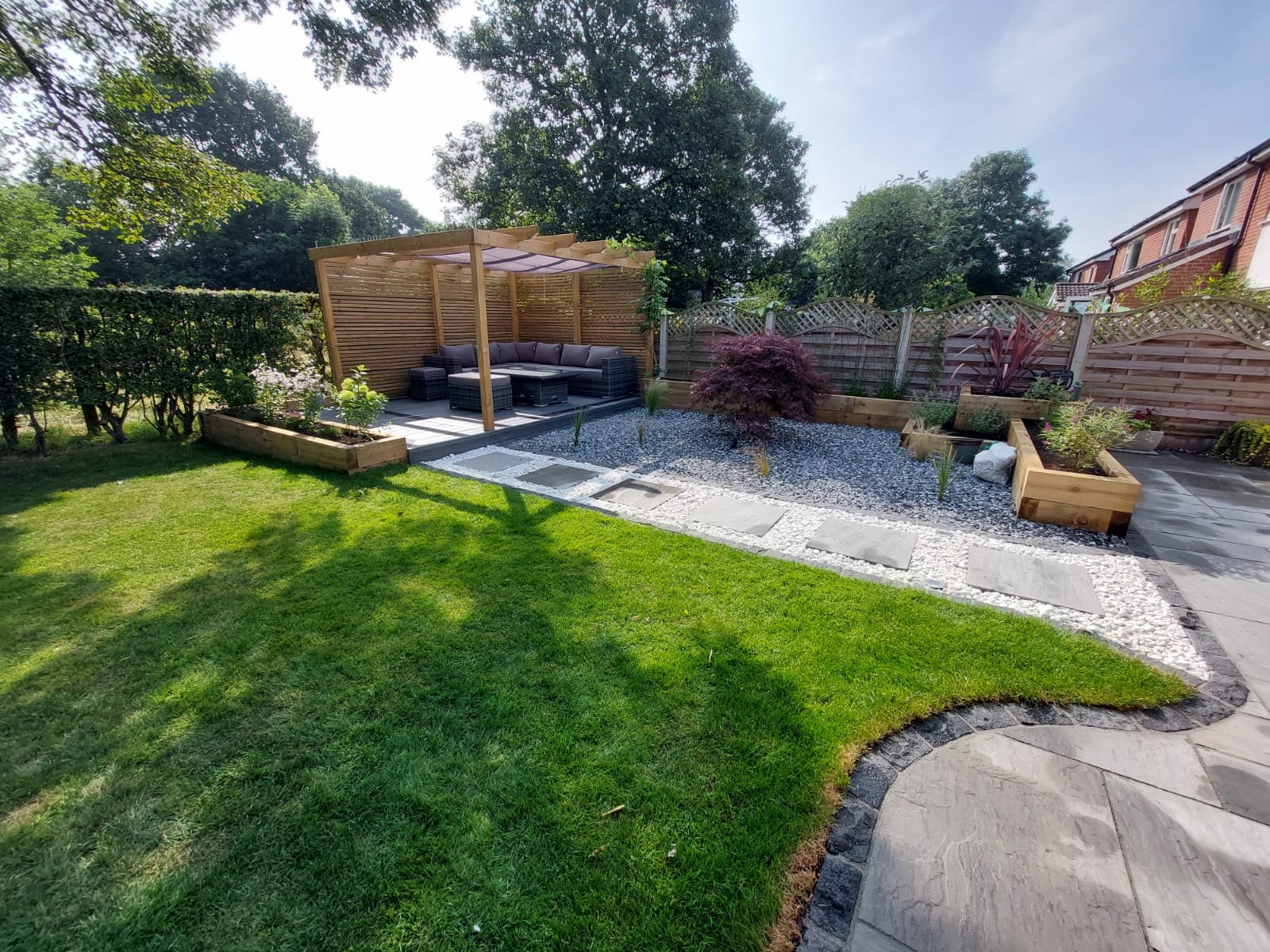 Finished Hazel Grove garden with lawn, planters and pergola