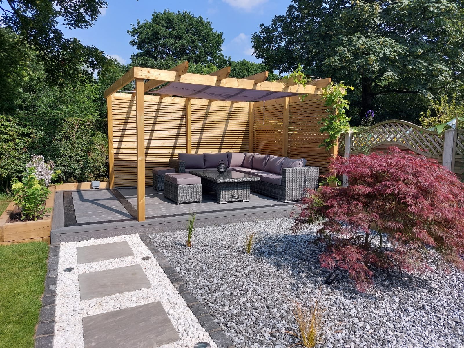 Pergola, composite decking and acer in a Hazel Grove garden