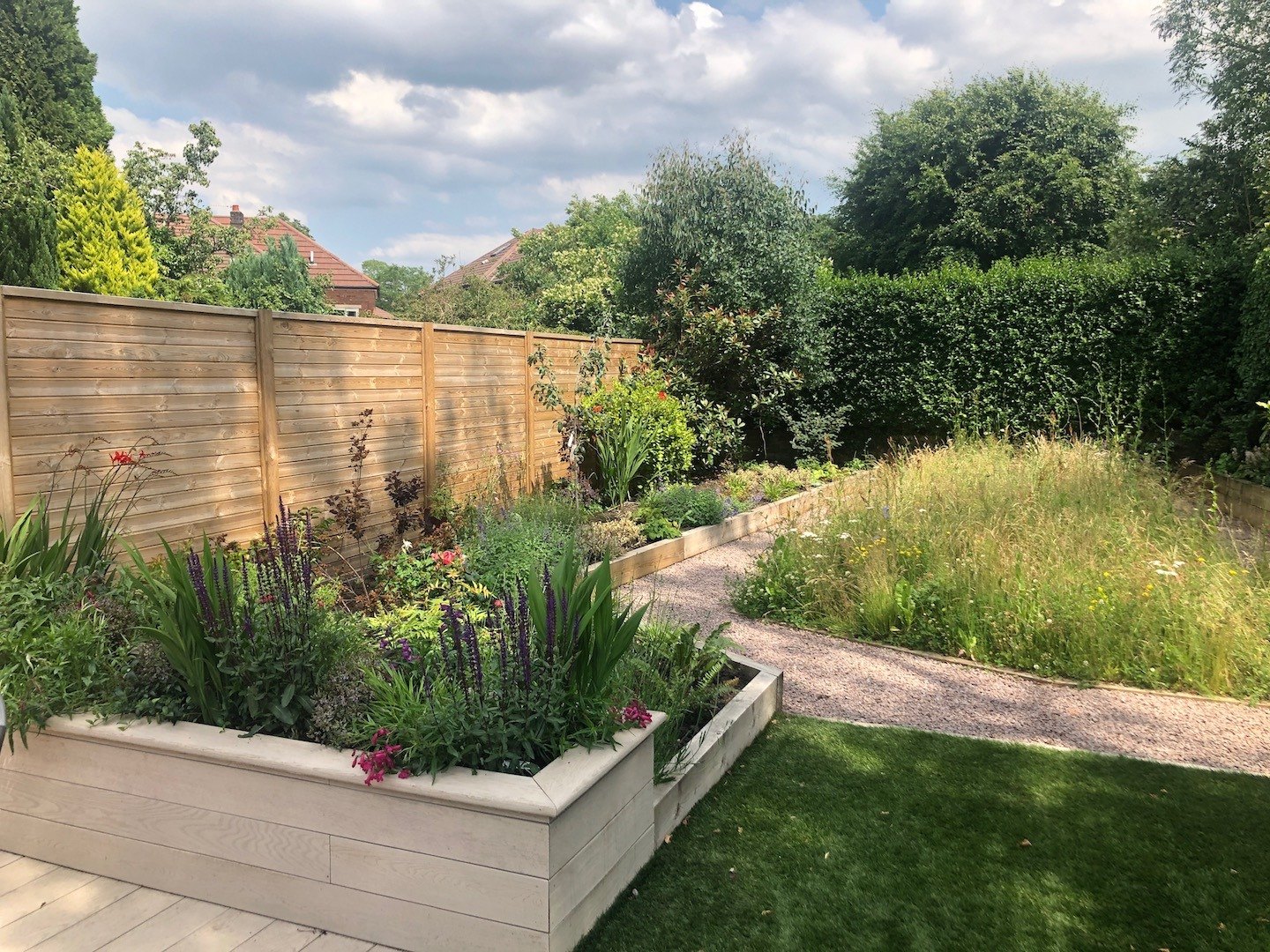 Raised beds with planting and timber fencing